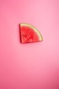 Conceptual shot with slice of ripe watermelon at pink background