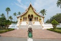 Back view of tourist woman looking to Haw Pha Bang an iconic landmark in the royal palace of Luang Prabang, the UNESCO world herit Royalty Free Stock Photo