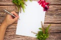 Conceptual space for text, which consisting of the handle of a pen writing on a blank piece of paper, azalea and basil flowers on Royalty Free Stock Photo