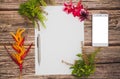 Conceptual space for text, which consists of blank paper, azalea, basil flowers, mobile phones and pen on a wooden background.top