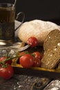 Conceptual still life of sliced bread, cherry tomatoes, glass of