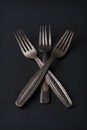 Conceptual still life of three vintage silver forks