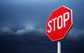 Conceptual stop sign with stormy clouds background. Royalty Free Stock Photo