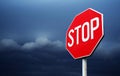 Conceptual stop sign with stormy clouds background.