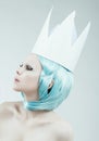 Conceptual studio portrait of woman with cyan hair