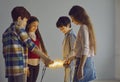 Conceptual studio shot of happy smart little children holding glowing light bulbs Royalty Free Stock Photo