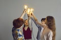 Conceptual studio shot of team of smart little children holding glowing light bulbs Royalty Free Stock Photo