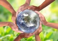 Conceptual symbol of multiracial human hands surrounding the Earth globe. Unity, world peace, humanity concept