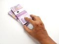 Conceptual, Top View Hand Offering Stack 10000 Rupiah Indonesia Paper Money at white background