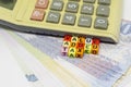 Value added tax texts on colorful alphabet beads and calculator over riyals banknotes Royalty Free Stock Photo