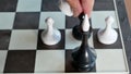 Conceptual video of bribery, traitor or betrayer. black king, surrounded by white figures give bribe then white chess pawn