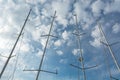 Conceptual view of frout sail boat masts under cloudy sky. Royalty Free Stock Photo