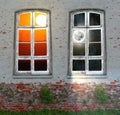 Conceptual view from retro window in the middle of  abandoned brick wall with growing green plants Royalty Free Stock Photo