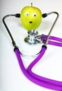 Doctors stethoscope and an eating apple Royalty Free Stock Photo