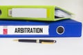 conceptual word arbitration on folder on white background