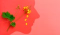 Conceptual work of man and nature. Flower and the silhouette of a man`s head on a red background