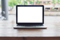 Conceptual workspace, Empty space wooden desk with on laptop screen and wireless mouse in home blurred background at light bokeh.