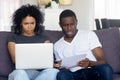 Confused black couple have problems with online paying Royalty Free Stock Photo