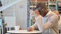 Concerned African Man Thinking in Cafe, Worrying Royalty Free Stock Photo