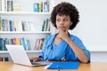 Concerned afro american nurse or medical student at computer Royalty Free Stock Photo