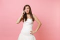 Concerned bride woman in white wedding dress looking up have problem with planning wedding talking on mobile phone Royalty Free Stock Photo