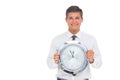 Concerned businessman holding clock