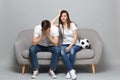 Concerned couple woman man football fans cheer up support favorite team with soccer ball covering face with hands