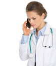 Concerned doctor woman speaking mobile phone