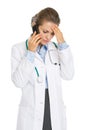 Concerned doctor woman talking mobile phone