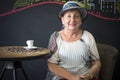 Elegant elderly woman sitting in the cafe place Royalty Free Stock Photo