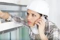 concerned female builder using smartphone Royalty Free Stock Photo