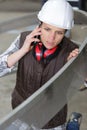 concerned female contractor using smart phone Royalty Free Stock Photo