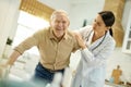 Worried medical worker assisting elderly man with getting up Royalty Free Stock Photo