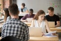 Concerned female reading paper report in coworking space