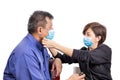 Concerned mature Asian Chinese couple wearing face mask for protection against influenza virus