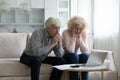 Concerned mature husband and wife frustrated about overspending family budget