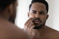 Concerned metrosexual young Black guy with stylish beard Royalty Free Stock Photo
