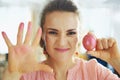 Concerned modern woman showing hands stained with egg