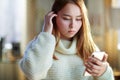 Concerned modern teenage girl with smartphone texting