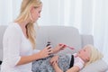 Concerned mother giving her daughter medicine