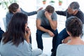 Concerned patients comforting another in rehab group