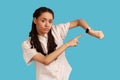 Concerned punctual woman pointing finger at smartwatch on her wrist, look at time, hurry up and act. Royalty Free Stock Photo