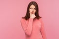 Concerned puzzled woman with brown hair in pink sweater thinking over dilemma, trying to find out of situation