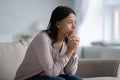 Sad African woman sit on sofa thinking of life troubles Royalty Free Stock Photo