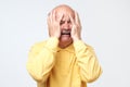 Concerned senior man pressing hands to head panicking. Crying of bad news Royalty Free Stock Photo