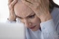 Concerned stressed mature business lady touching head Royalty Free Stock Photo