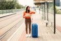 Concerned Traveler Lady With Suitcase Checking Watch at Train Station Royalty Free Stock Photo