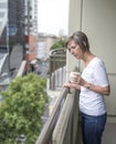 Concerned Woman on Balcony.