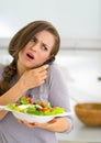 Concerned woman with salad talking mobile phone Royalty Free Stock Photo