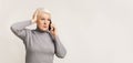 Concerned woman talking on phone, holding hand on head Royalty Free Stock Photo